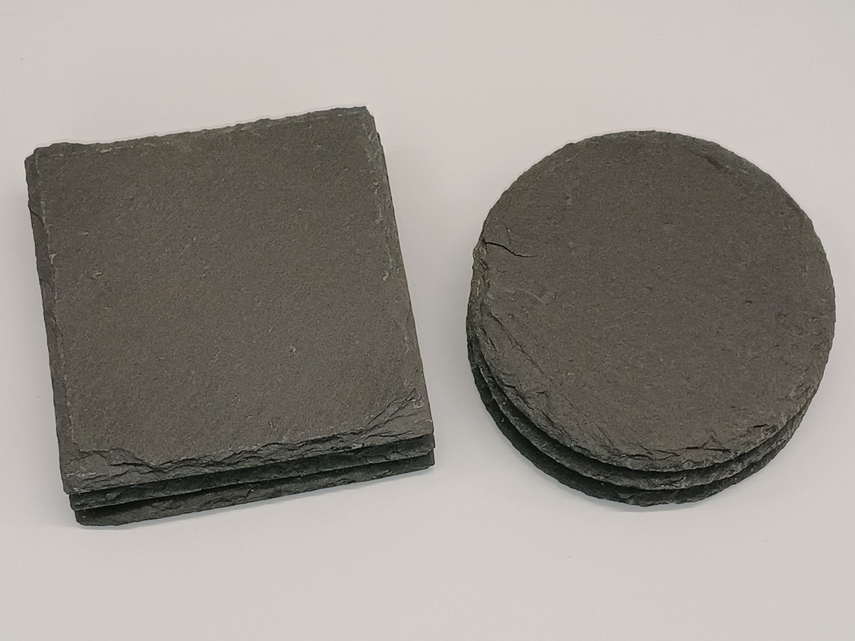 Stacks of square and round natural slate coasters